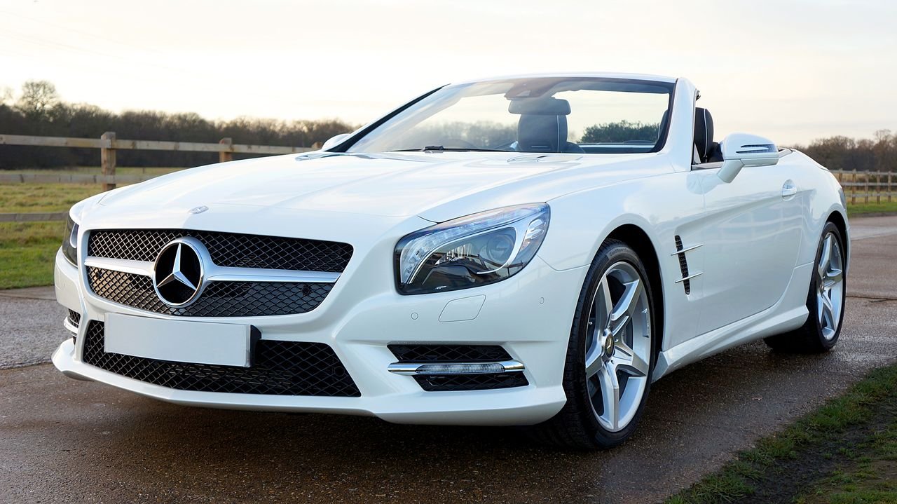 home-hero Elegant white Mercedes-Benz convertible on a scenic countryside road in the United Kingdom.